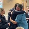 Jason Quinn gives a hug to Orleans Firefighter Kyle Simkins and others involved in his rescue during a ceremony held by the Orleans Fire Department Monday night at town hall. Others involved in the December rescue on Overland Way included Orleans Fire Lt. Thomas Pellegrino, Fire Lt. Aaron Burns, Firefighter Gabby Parker, Officer Neill Bohlin of the Brewster Police Department and Shannon Filteau, a civilian who called 911.  RYAN BRAY PHOTOS