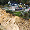 Over 100 feet of bluff erosion can be seen in this aerial view of the Monomoy National Wildlife Refuge, as U.S.Fish and Wildlife personnel demolish the 100 year old Coast Guard garage. The building had been used as a dormitory for housing refuge staff, interns and visiting researchers. MILTON LEVIN PHOTO