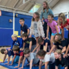 Students in Mrs. Richers and Mrs. Bruemmer’s fourth grade classes form a human pyramid during a visit from Cirque of the Sea