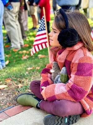 Lana Chianciola quietly observes Saturday’s Veterans’ Day ceremony at Veterans’ Memorial Park in Orleans. KELLY CHIANCIOLA PHOTO