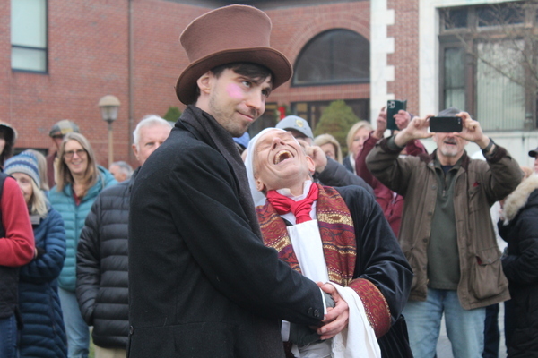 Ebenezer Scrooge and his nephew Fred  share a joyous moment during the village performance of "A Dickens Of A Christmas- A Christmas Carol in Harwich" on Saturday.