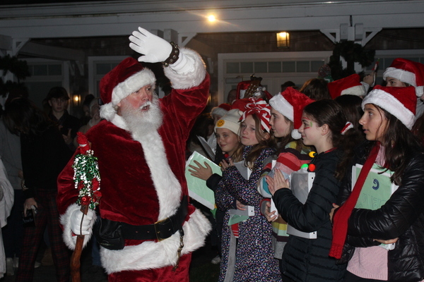 Santa greets members of the Cape Cod Lighthouse Charter School chorus while performing at the Wequassett Resort and Golf Club,