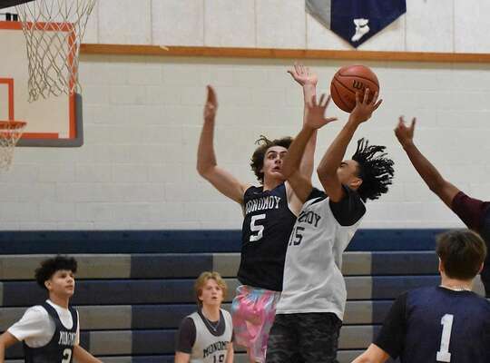 Among the leaders for this year’s Monomoy’s boys team will be junior Jackson Rocco, seen here going for a block during a recent practice.