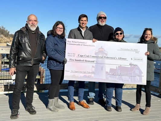 Cape Cod Commercial Fishermen’s Alliance Officials and State Rep. Dylan Fernandes celebrated a $500,000 state earmark for the organization at the fish pier Wednesday. From left, Senior Outreach and Policy Advisory Seth Rolbein, Accounting and Operations Manager Holly Buddensee, Fernandes, CEO John Pappalardo, COO Mel Sanderson, and Development Coordinator Brigid Krug. TIM WOOD PHOTO