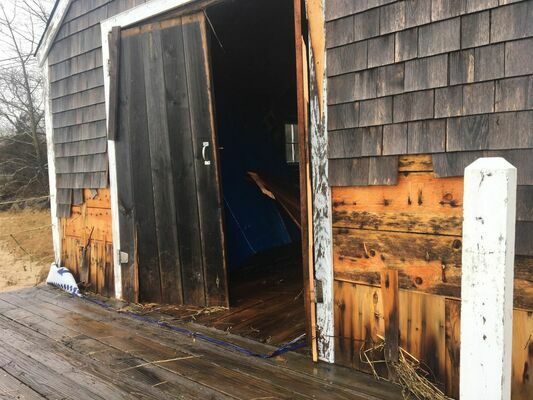 A boathouse on Pleasant Bay in South Orleans took a pounding from the high surf and storm surge. COURTESY PHOTO