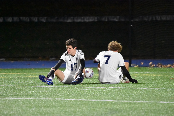 Monomoy senior Stephen Kelly, left, and junior Ryan Laramee sit on the turf at the end of Saturday's Division 4 state championship loss to Lynnfield at Scituate High. BRAD JOYAL PHOTO
