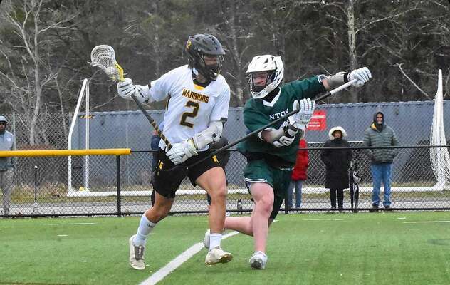 Nauset senior Ryder Holm keeps the ball away from a Canton defender.