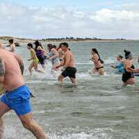 The rush of swimmers going into the water was, somehow, less urgent than the exit stampede.